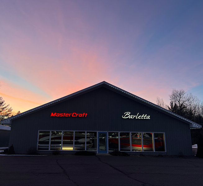 mastercraft barletta neon signs on a building in front of sunrise
