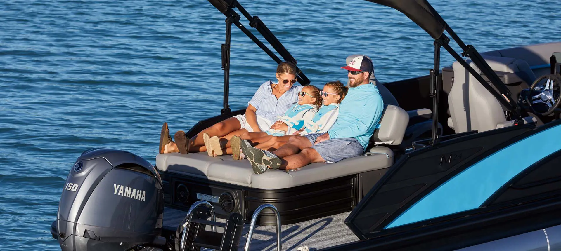bennington boat on water family sitting inside